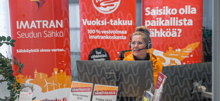 Kuvassa asiakaspalvelija työssään tiskin takana.